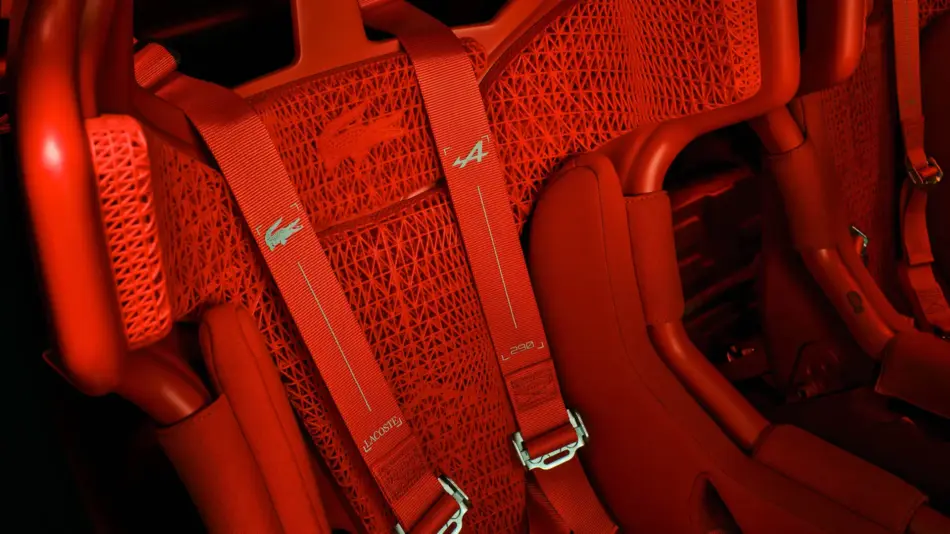 Red racing style car seats with woven backs and red harnesses buckled in place