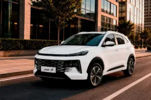 White SUV parked on a city street in front of modern glass buildings, front view showing the JAC 6 badge on the grille.