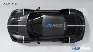Top-down view of a black Alpine A110 Future concept car with white racing stripes and blue A110 Future branding on the hood; Alpine logo in the top-left.