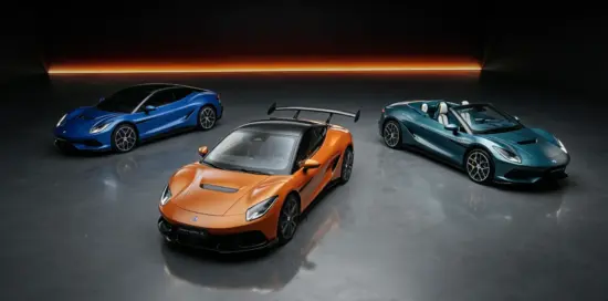 Three luxury sports cars in a dark studio with an orange glow along the back wall.