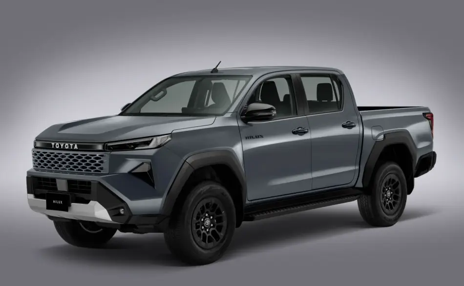 Hilux 2027ALTA Memo Lira Front left angled view of a gray Toyota Hilux pickup with bold grille and rugged bumper details