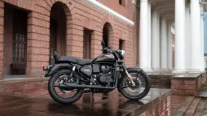 Black Royal Enfield Bullet motorcycle parked on wet brick steps beside a red brick building with arches and a white-columned portico.