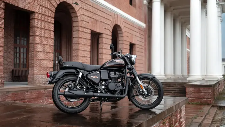 Black Royal Enfield Bullet motorcycle parked on wet brick steps beside a red brick building with arches and a white-columned portico.